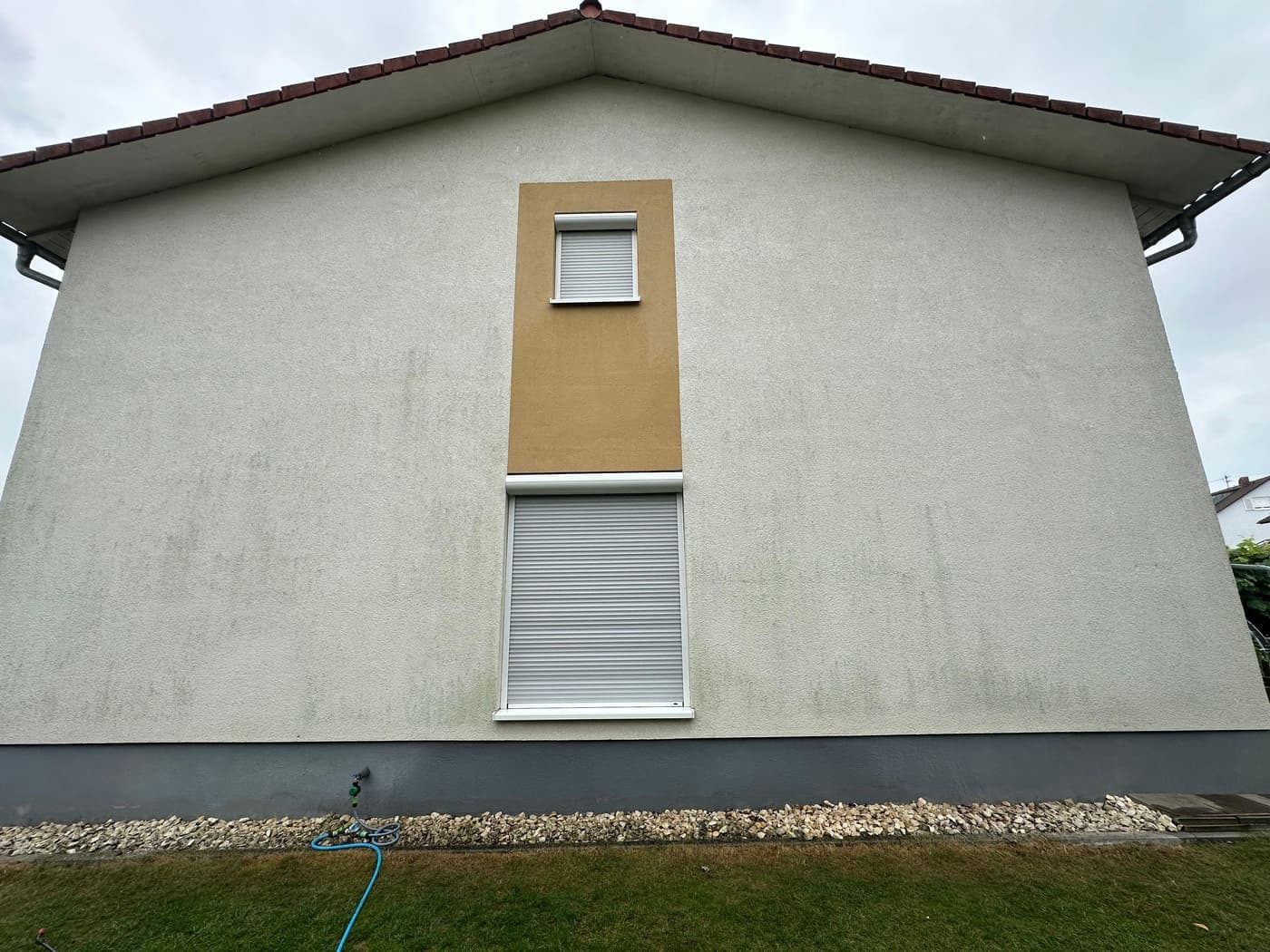 Giebelwand: Teilfläche gereinigt – sichtbarer Unterschied zum noch verschmutzten Rest